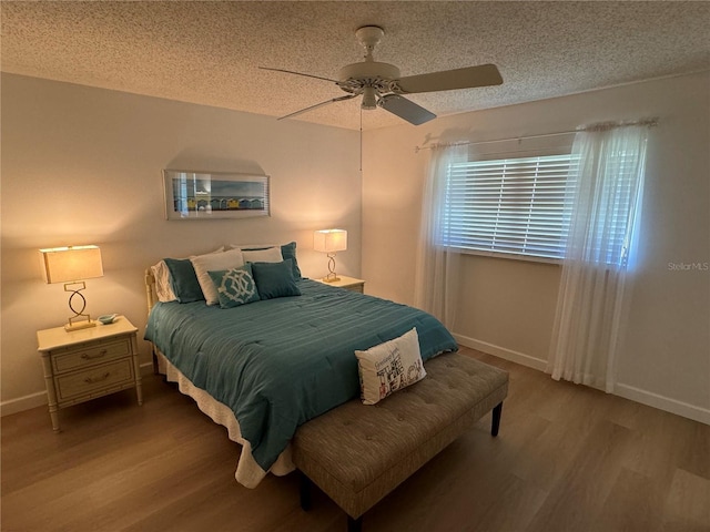 bedroom featuring wood-type flooring, a textured ceiling, and ceiling fan