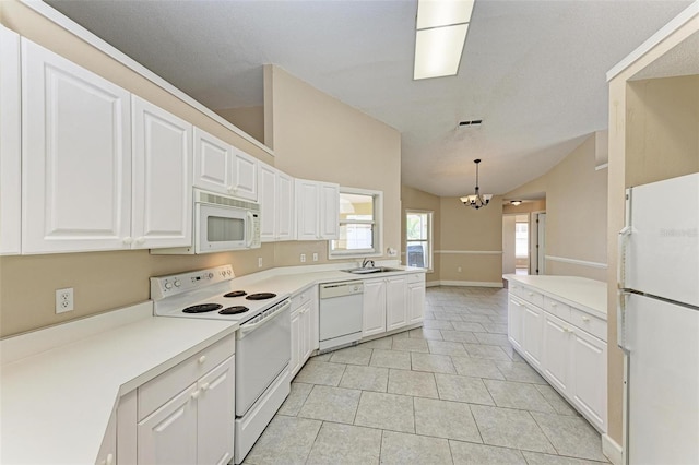 kitchen featuring white appliances, vaulted ceiling, a chandelier, decorative light fixtures, and sink