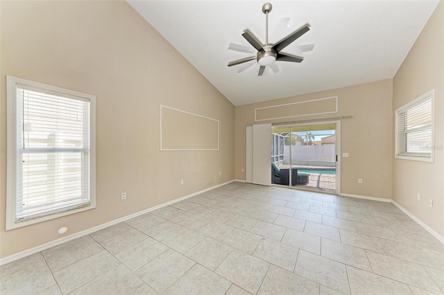 empty room featuring lofted ceiling, ceiling fan, and light tile patterned floors