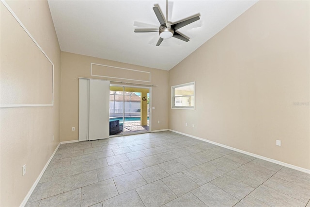 tiled spare room with ceiling fan and vaulted ceiling