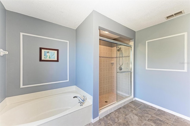 bathroom featuring a textured ceiling and plus walk in shower