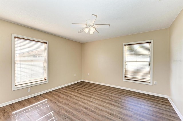 spare room with ceiling fan and hardwood / wood-style flooring