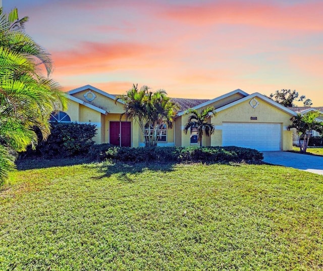 ranch-style home with a lawn and a garage