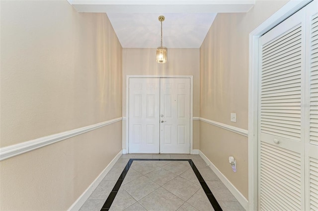 doorway to outside with light tile patterned flooring