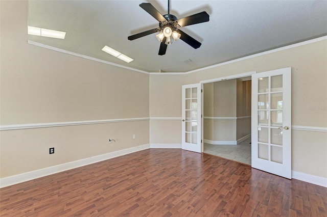 empty room featuring ceiling fan, french doors, crown molding, and hardwood / wood-style floors