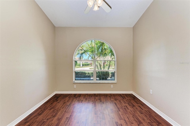 unfurnished room featuring ceiling fan and dark wood-type flooring