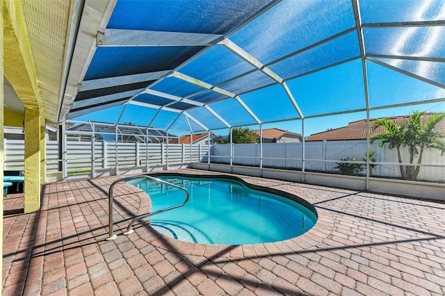 view of pool with a patio and glass enclosure