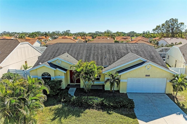 view of front facade featuring a shingled roof, a residential view, driveway, and stucco siding