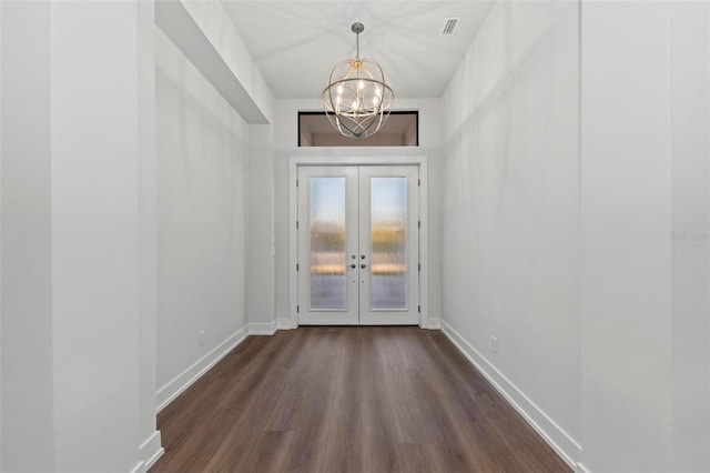 doorway to outside featuring dark wood-type flooring, a chandelier, and french doors