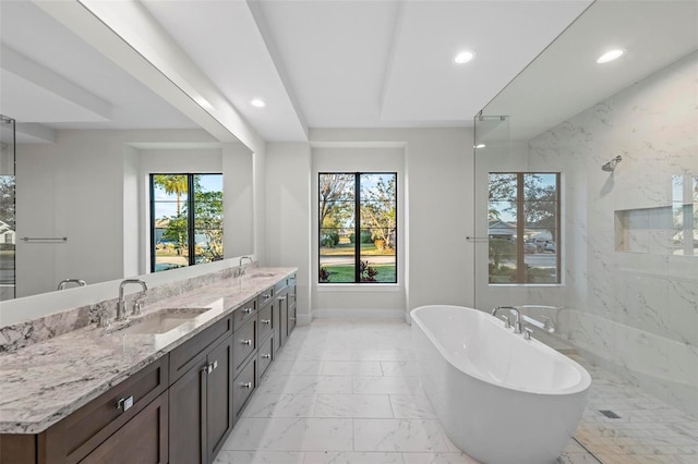 bathroom featuring shower with separate bathtub, vanity, and a healthy amount of sunlight