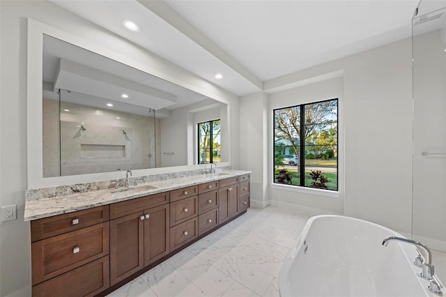 bathroom with vanity and independent shower and bath