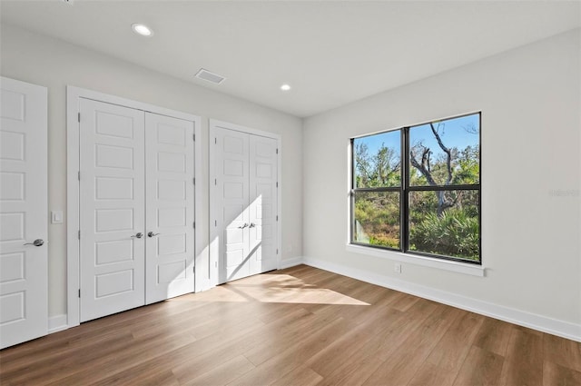 unfurnished bedroom with hardwood / wood-style floors