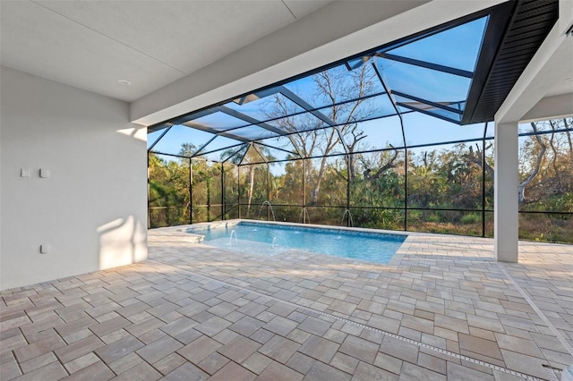 view of swimming pool with a patio and glass enclosure