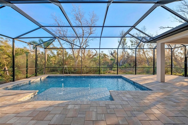 view of swimming pool with a lanai, pool water feature, and a patio