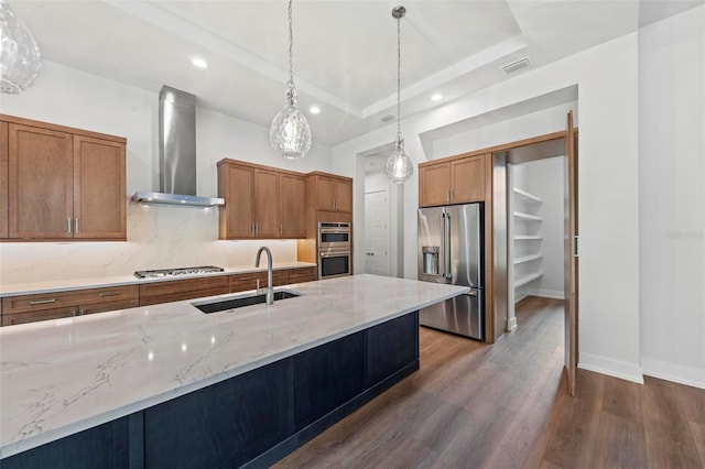 11323 Rivers Bluff Cir, Lakewood Ranch, FL 34202 - kitchen with a sink, wall chimney range hood, stainless steel appliances, and brown cabinetry