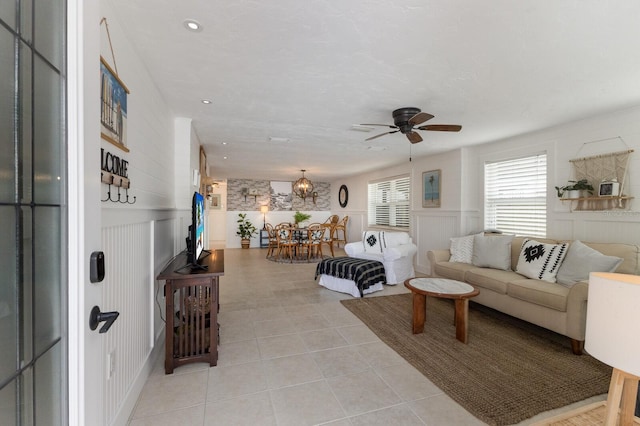 tiled living room with ceiling fan