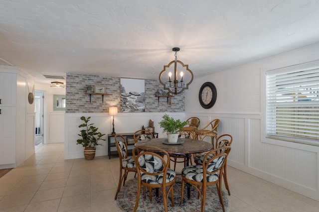 dining area with light tile patterned floors and a chandelier