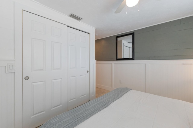 bedroom with ceiling fan and a closet