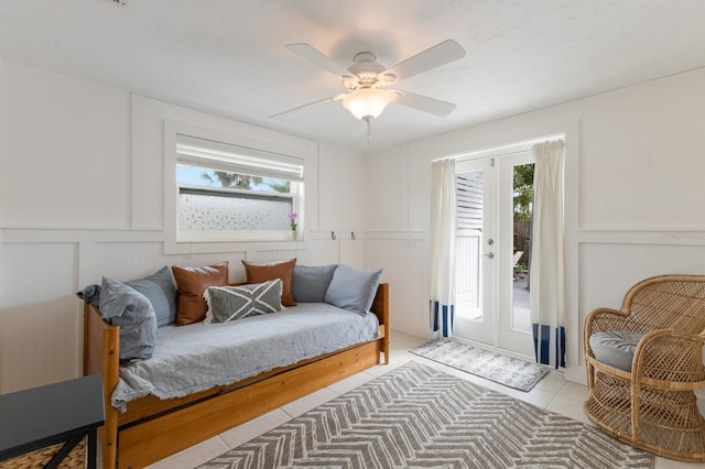 sitting room featuring light tile patterned flooring, ceiling fan, and french doors