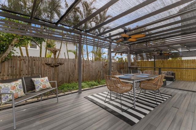 wooden deck featuring ceiling fan and a pergola