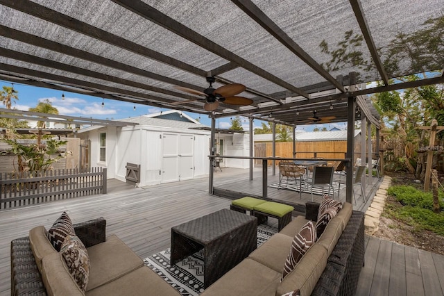 wooden terrace featuring a pergola, an outdoor hangout area, ceiling fan, and a shed