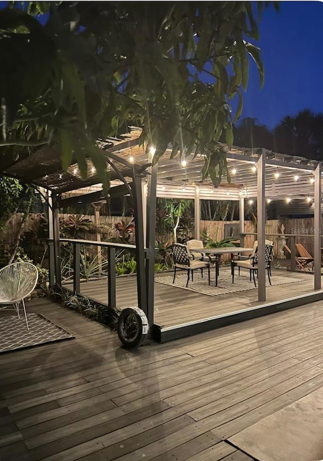 deck at night with a pergola