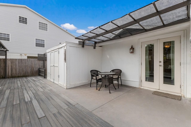 deck featuring a patio, a pergola, and french doors