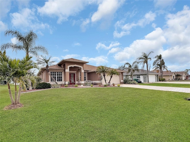 view of front of property with a garage and a front yard