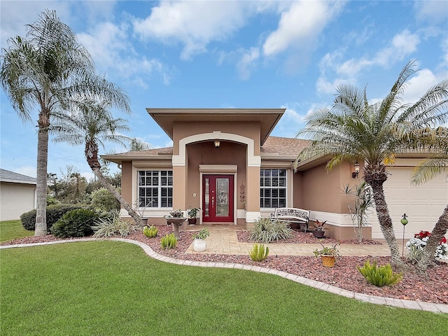 view of front of house featuring a front yard and a garage