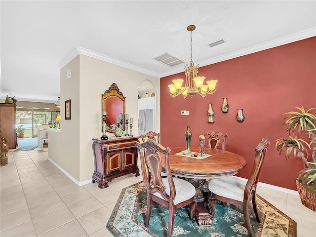 tiled dining room with ornamental molding and a notable chandelier