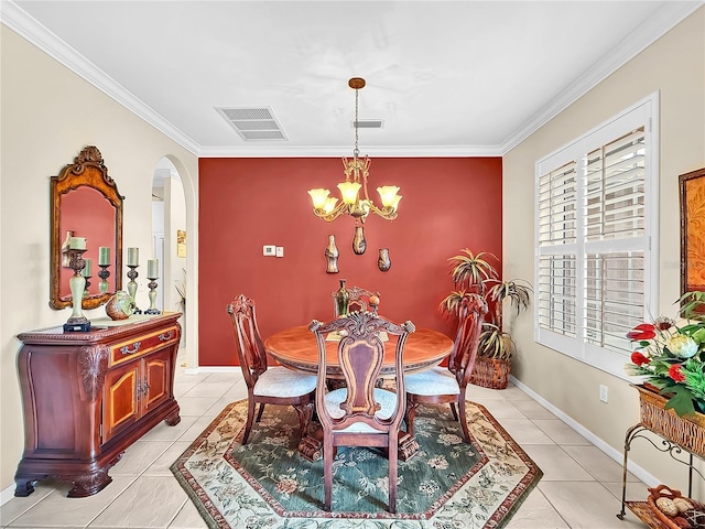 dining room with light tile patterned floors, crown molding, and a chandelier