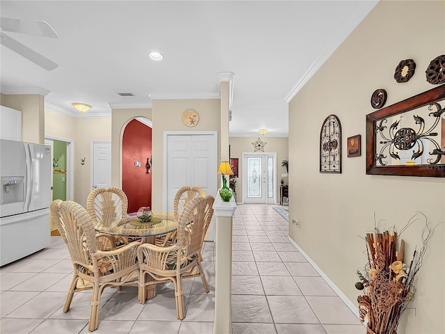 dining area featuring light tile patterned floors and ornamental molding