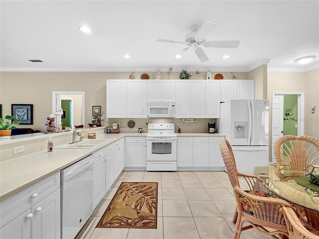 kitchen with light tile patterned floors, white appliances, white cabinetry, and ornamental molding