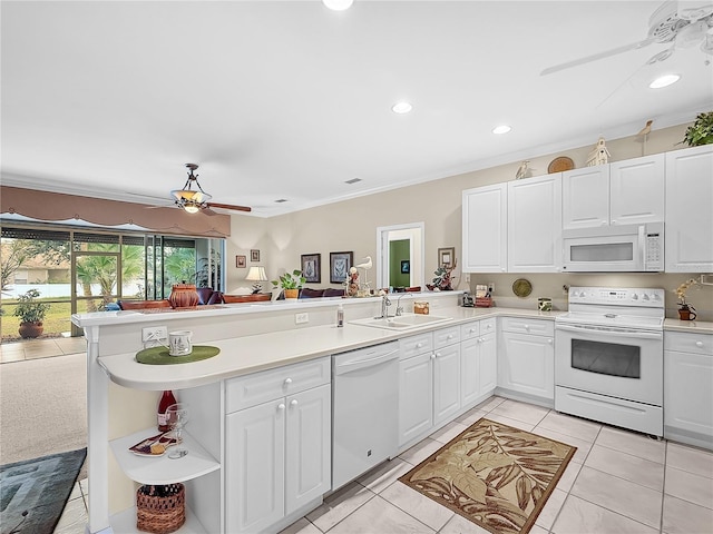 kitchen featuring white cabinetry, white appliances, and kitchen peninsula