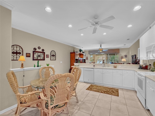 kitchen with kitchen peninsula, sink, crown molding, white appliances, and white cabinets