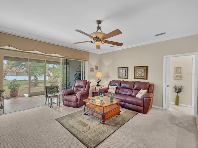 carpeted living room featuring ceiling fan and crown molding