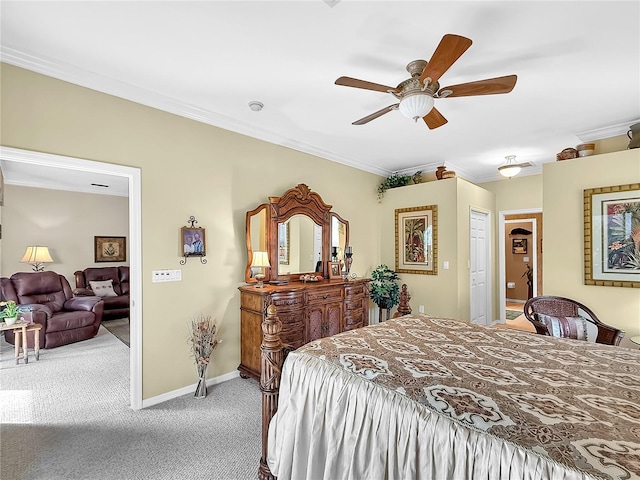 bedroom featuring ceiling fan, light colored carpet, a closet, and ornamental molding