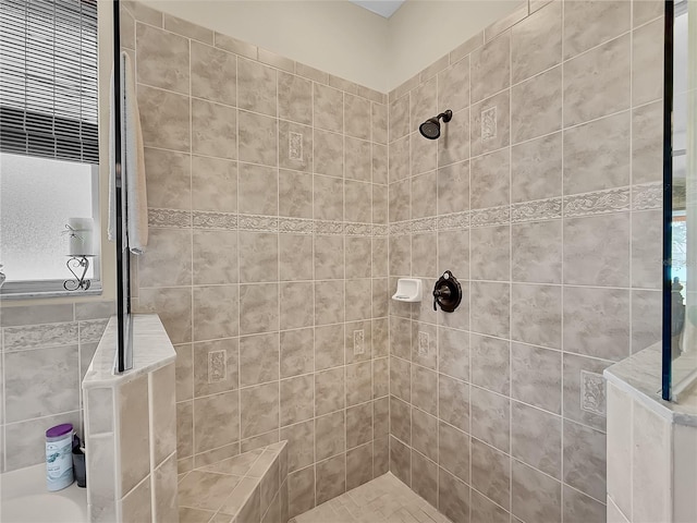 bathroom with tiled shower