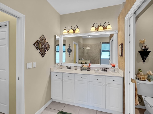 bathroom with toilet, tile patterned flooring, tiled shower, and vanity