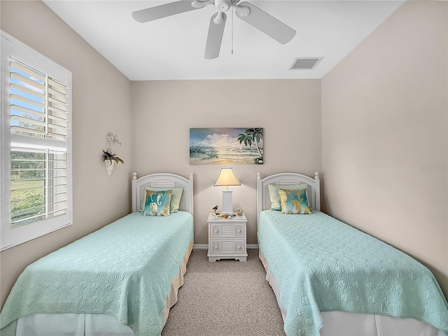 bedroom featuring light carpet and ceiling fan