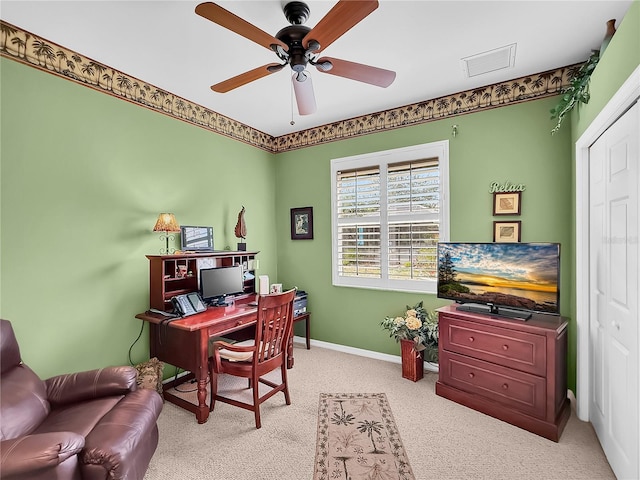 carpeted office space featuring ceiling fan