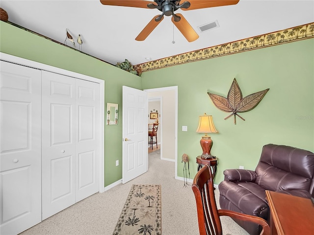 sitting room featuring ceiling fan