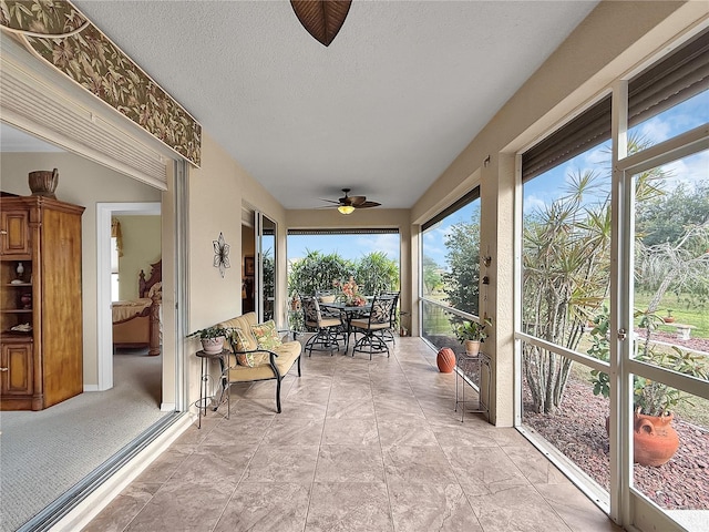 sunroom / solarium featuring ceiling fan