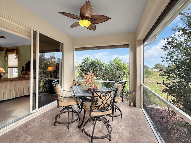 sunroom featuring ceiling fan