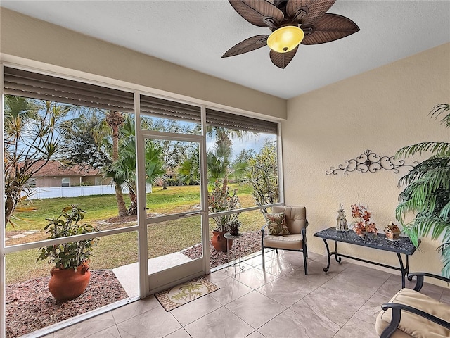 sunroom / solarium featuring ceiling fan