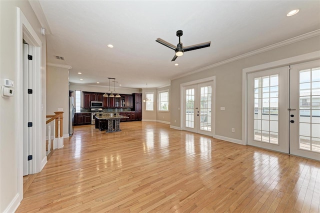 living room featuring ornamental molding, french doors, and light hardwood / wood-style floors