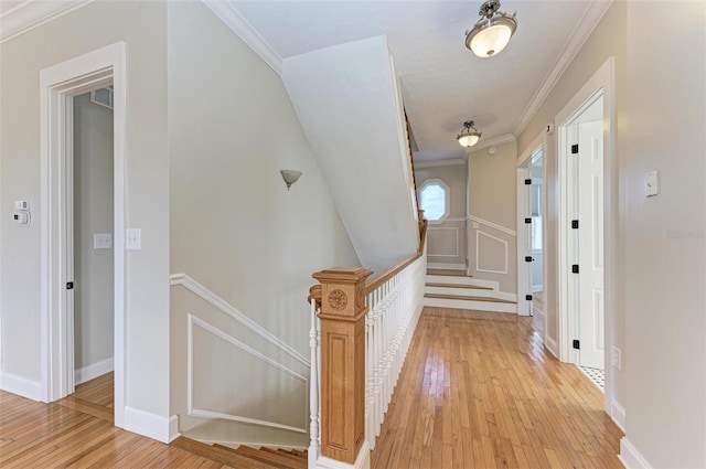 corridor featuring light hardwood / wood-style floors and crown molding