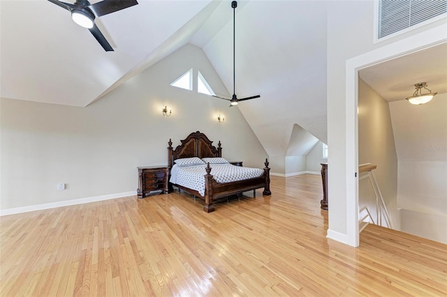 bedroom with ceiling fan, light wood-type flooring, and vaulted ceiling