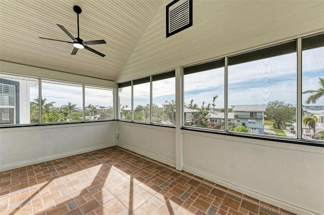 unfurnished sunroom featuring ceiling fan, vaulted ceiling, and wooden ceiling