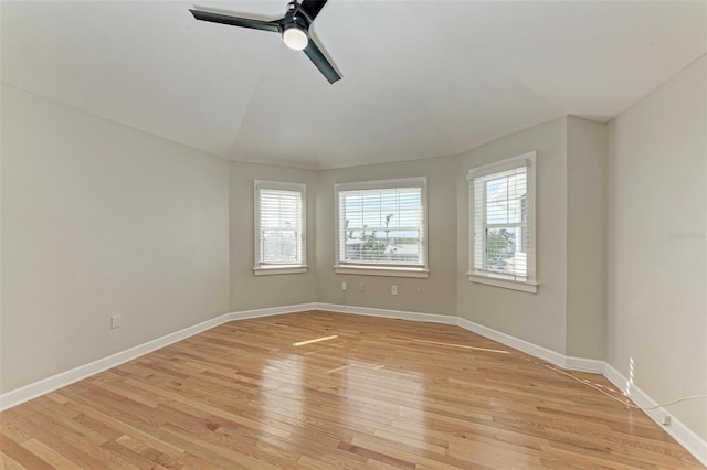 empty room featuring light wood-style flooring, baseboards, and ceiling fan